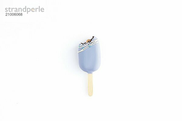 Isolated bitten blue cookie ice cream on a stick on white background. Flat lay with ice cream