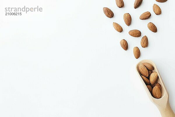 Raw almond kernels in wooden spoon on white background. Cosmetic and healthy food concept  Isolated and flat lay.