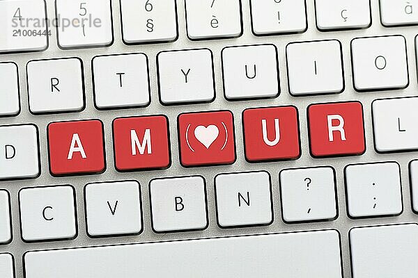 AMOUR writing on white keyboard with a heart sketch with parenthesis