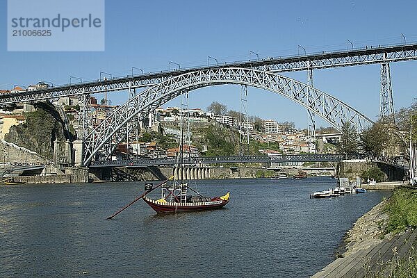 Place of interest  architecture  view from Vila Nova de Gaia to a Rabelo  boat on the river Douro and the bridge Ponte Dom Luis I  Porto  Portugal  Europe