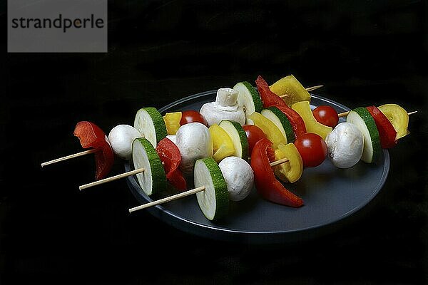 Colourful vegetable skewers on a plate  barbecue skewers