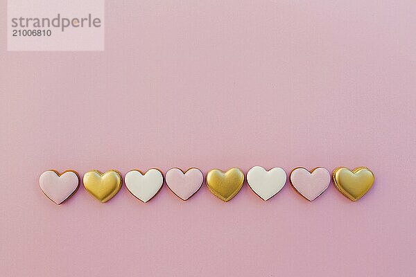 Pink background with sweet gingerbread heart cookies.