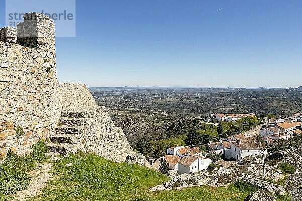 View of Marvao village with beautiful houses  church and wall with rocky landscape mountains behind