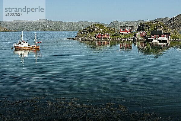 Small norwegian wooden houses and boat near Honningsvag  Norway  Europe