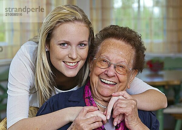 A grandson visits his grandmother Fun and joy while hugging  Vienna  Austria  Europe