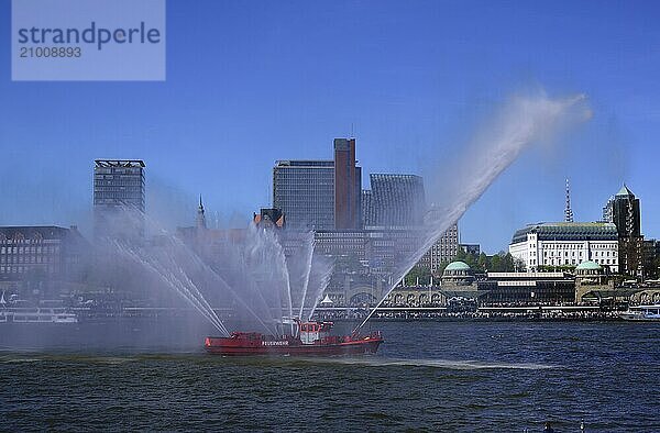 Europe  Germany  Hamburg  Elbe  View across the Elbe to the St. Pauli Landungsbrücken  Skyline St. Pauli  Fire boat in action  Hamburg  Hamburg  Federal Republic of Germany  Europe