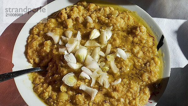 Fava  A plate of a traditional dish  chunky and garnished with onions  served on white crockery  Drakona  Slowfood  Restaurant Dounias  Lefka Ori  White Mountains  Massif  West  Crete  Greece  Europe