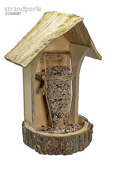 Homemade wooden bird feeder with glass bottle and birdseed cut out on white