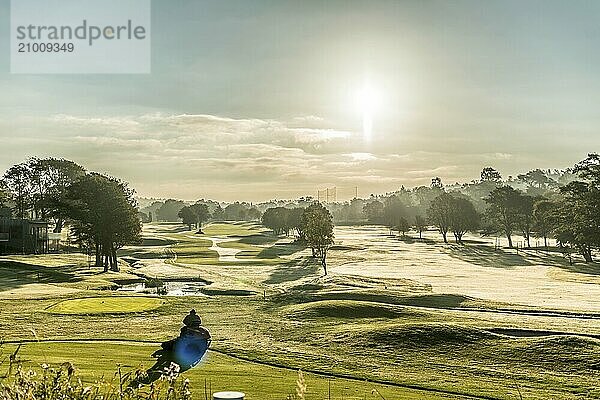 Gothenburg  Sweden  October 05 2015: Early morning cutting the grass of the golf course at Göteborgs Golfklubb  Slightly foggy morning over green trees  Europe