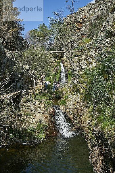 Tourists in beautiful waterfall in Penedo Furado Passadico walkway in Vila de Rei  Portugal  Europe