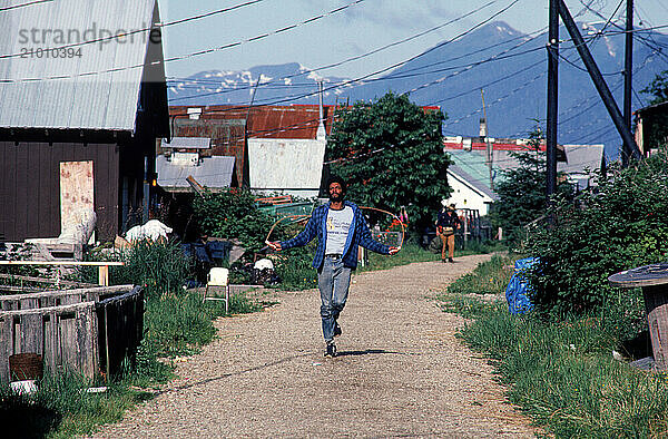 A man skipping down a street  Alaska  USA.