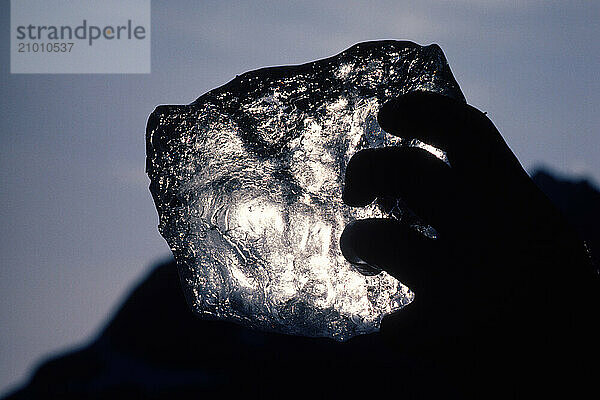 A large chunk of ice held to the sky  Alaska  USA.