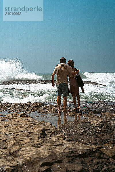 Friends hugging on the beach.