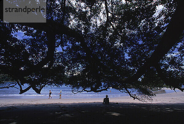 A man sitting at the sea shore under the sun  Costa Rica.