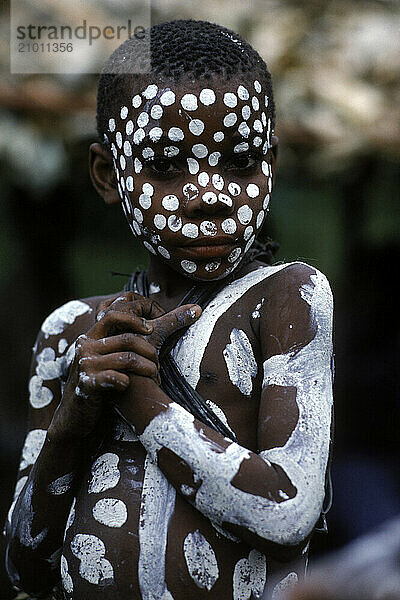 Pygmy girl decorated with white designs during a menstrual ceremony  Ituri Forest.