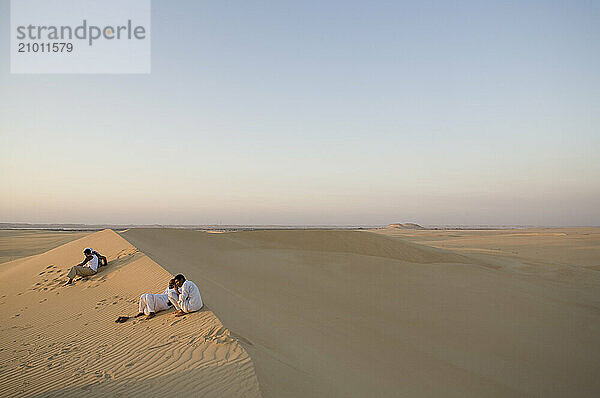 Couples watch the Egyptian sunset near El-Siwa  one of Egypt's desert oases