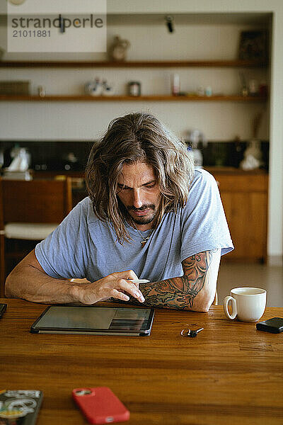 Man using tablet computer for work.