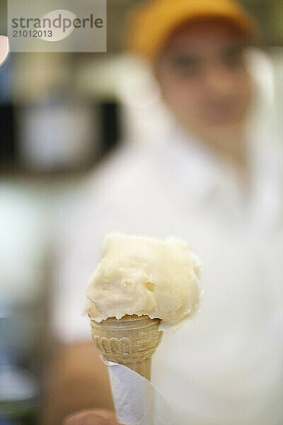 A gelato is held by an Italian worker in Siena.