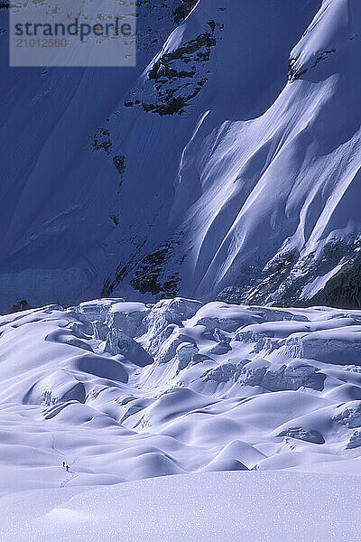 Two men approaching the North Face of Everest for some backcountry skiing  Tibet