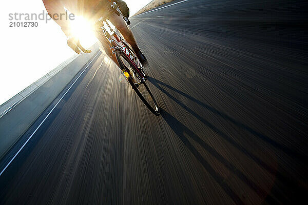 A man on road bike rides on the long open roads west of Salt Lake City  Utah