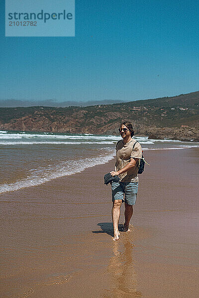 Happy friends walking on the beach.