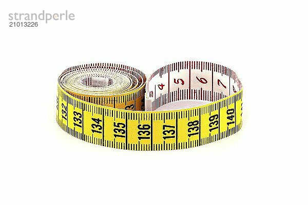 Spirals of yellow tape measure create a visual impression of motion  isolated white background