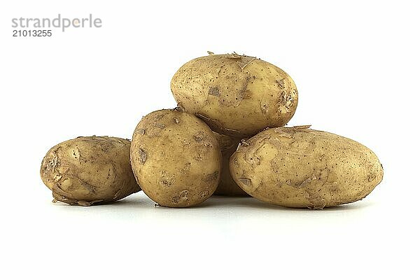 Group of fresh early potatoes  with a light brown skin and dark brown spots isolated on a white background