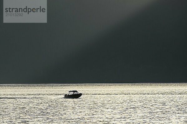 A motorboat sails in the Strait of Georgia along the coast of British Columbia  Canada  North America