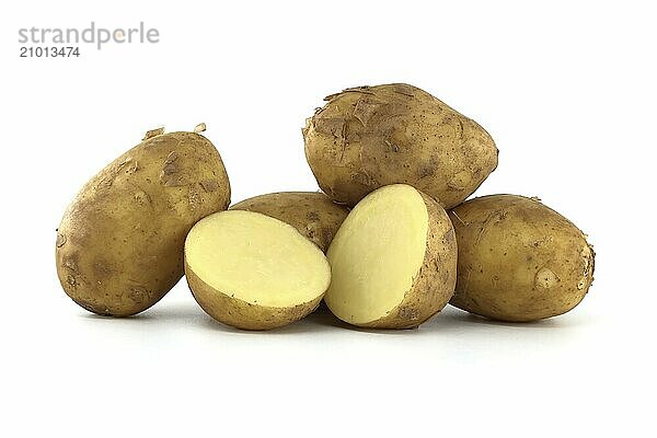 Group of fresh early potatoes  with a light brown skin and dark brown spots isolated on a white background  one potato bisected displaying its yellow interior