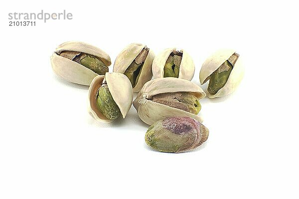 Pistachios in-shell and others peeled exposing the green nuts inside isolated on white background