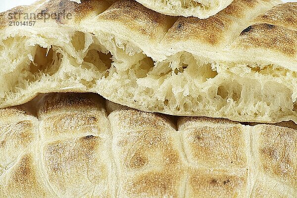 Pieces of pita flat-bread are stacked atop each other isolated on white background  typical fast food item  with the potential to be used as a snack