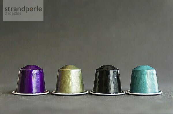 Beautiful colored coffee capsules on black background