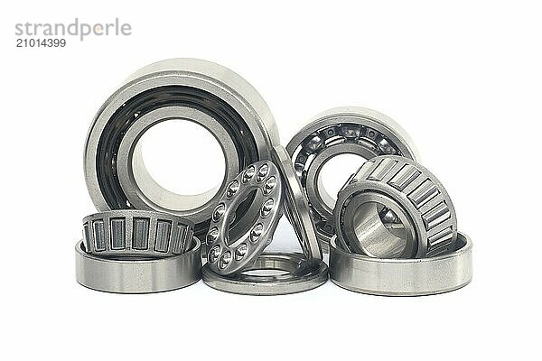 Array of bearings of varying sizes and types  including roller bearings and ball bearings isolated on a white background