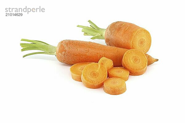 Whole carrot and sliced pieces  all with a bright orange color prepped for cooking or for use in a dish like a salad or stir-fry isolated on a white background