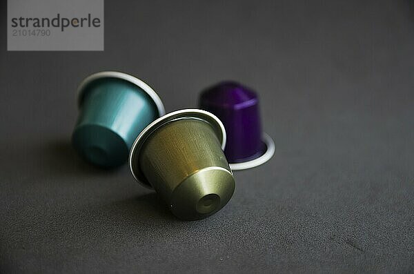 Beautiful colored coffee capsules on black background