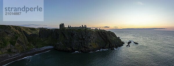 Dunnottar Castle  castle ruins at sunrise on the cliffs  drone shot  Stonehaven  Aberdeenshire  Scotland  Great Britain