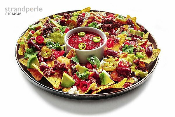 Loaded nachos. Mexican nacho chips with beef  guacamole sauce  cheese salsa  beans and peppers  isolated on a white background  Food photography