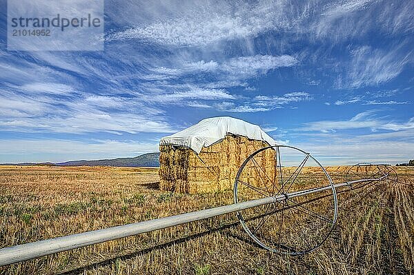 A large haystack in the Rathdrum Prairie under a rich partly cloudy blue sky in North Idaho