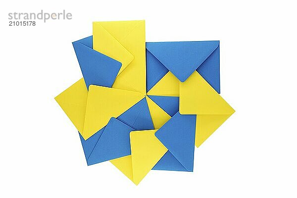 Collection of blue and yellow paper envelopes arranged against a white background  arrangement gives the appearance of a three-dimensional  exploding geometry that adds a sense of depth and vibrancy