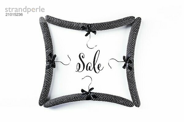 A frame of satin padded hangers with the word Sale  a banner design on white background  Food photography