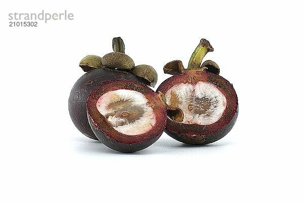 Whole and halved mangosteen fruits display their white inner flesh  speckled with dark purple spots and featuring two discernible black seeds  set against a white background