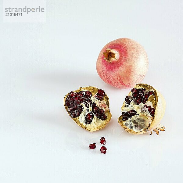 Juicy pomegranate fruits on white background