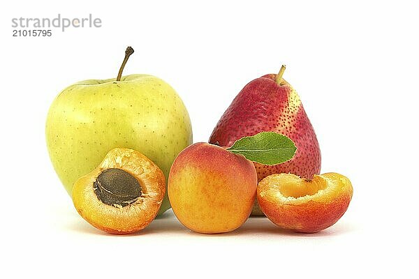 Whole and halved ripe apricots  multicolored pear and green apple isolated on a white background. Multivitamin and juicy rich fruits