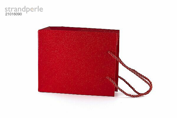 Red paper shopping bag isolated on white background. Gifts and shopping concept