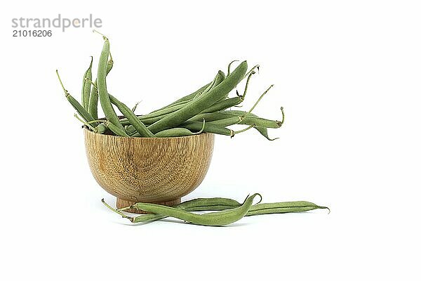 Fresh green beans in a wooden bowl isolated on a white background with full depth of field