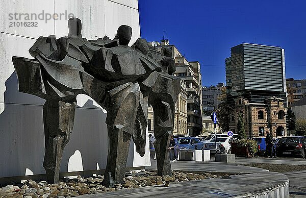 Monument at Piata Libetati in memory of the victims of the revolution and Paucescu House  headquarters of the Association of Romanian Architects. Bucharest  Romania  Europe