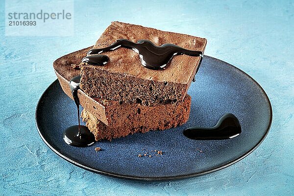 Chocolate brownie with syrup cream  simple coffee cake  on a vibrant blue background