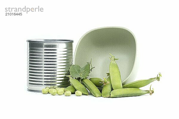 Tin can alongside fresh garden peas pods with green leaves isolated on a white background  sweet peas or English peas