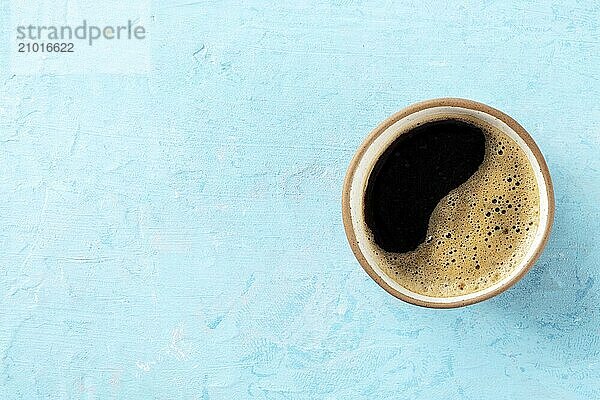 Coffee cup  top shot on a blue background with a place for text  espresso drink in a simple mug  Food photography  Food photography