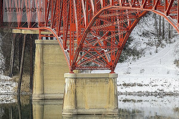 A close up of the support structure of a red bridge in Ione  Washington